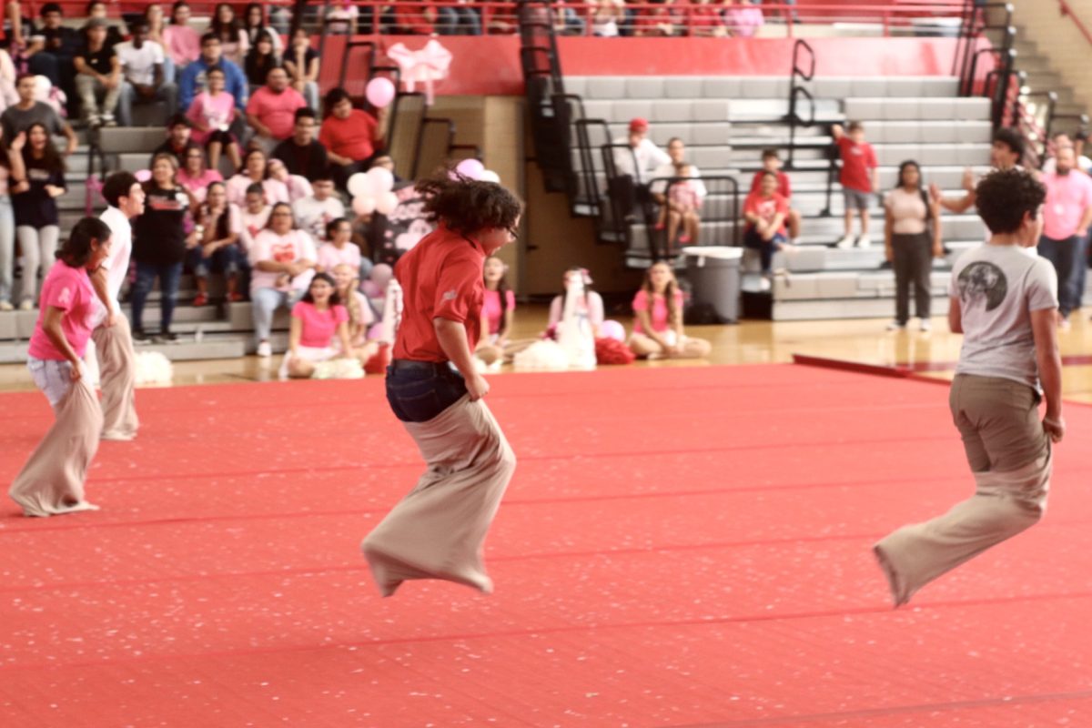 Representatives from each grade compete in a potato sack race during the Student Council game. The theme for the pep rally was "Pink Out", in recognition of Breast Cancer Awareness Month.