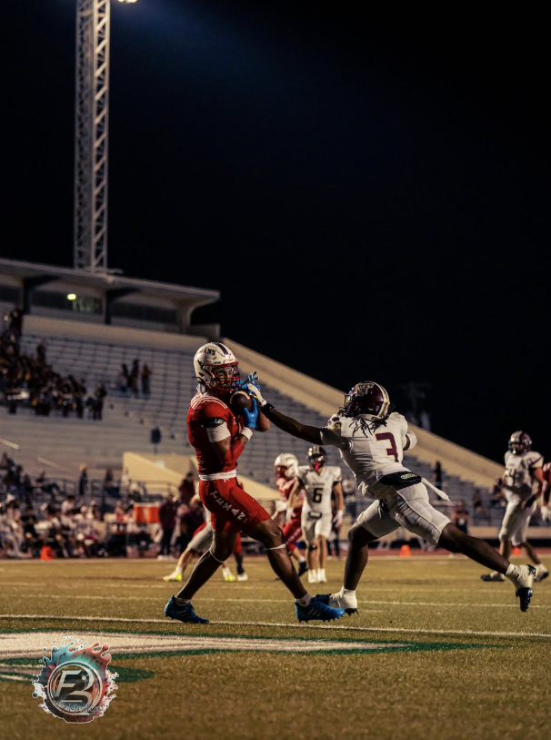 Texans senior receiver Huzefa Ulah with a catch past TM defenders in the second game of the season for a touchdown.