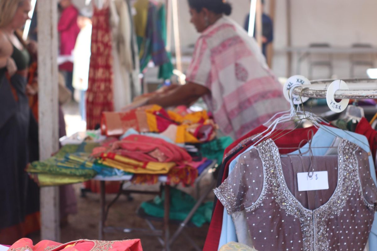 Venue volunteers manage a booth selling sarees and other garments.